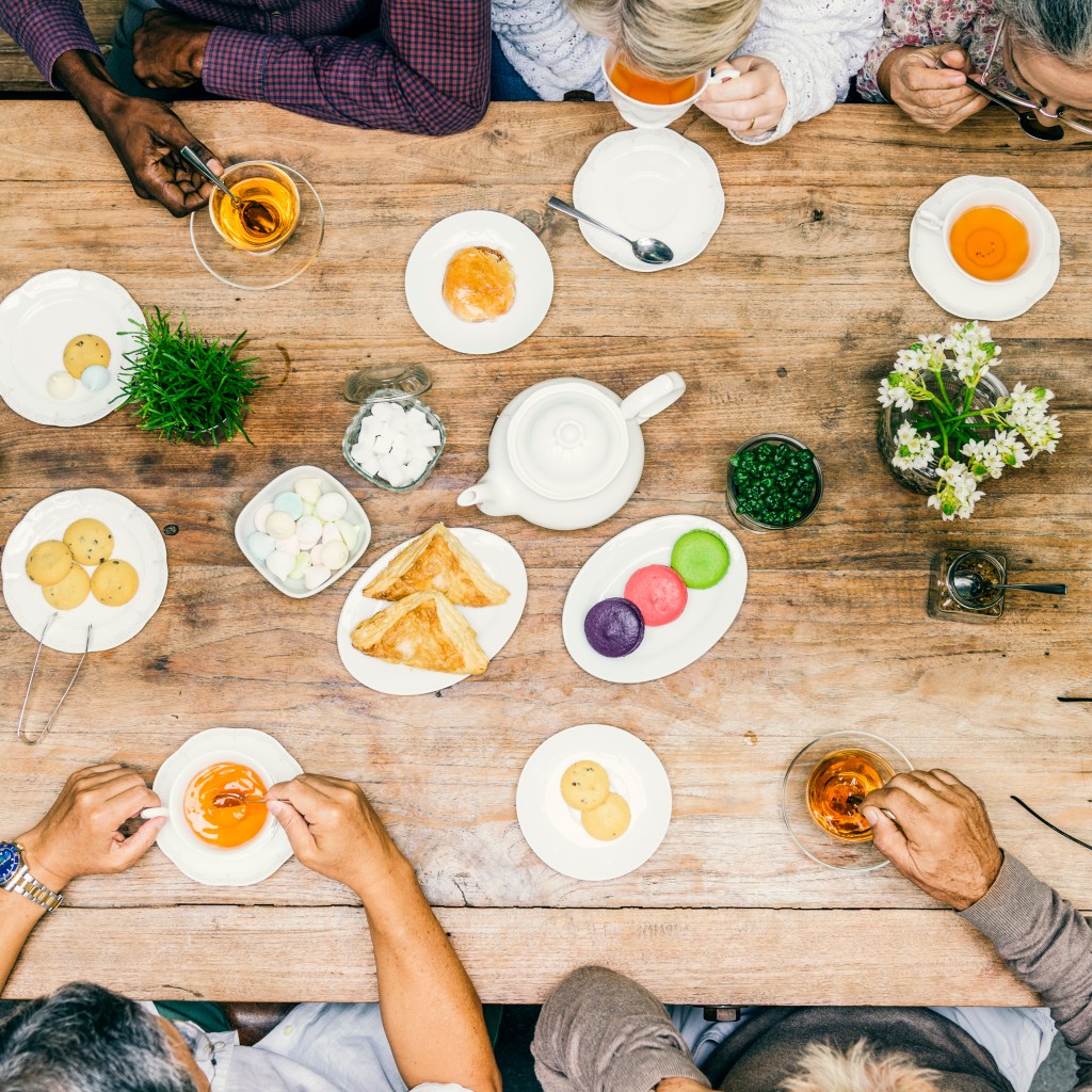 Restaurant owners reviewing menu performance with financial data